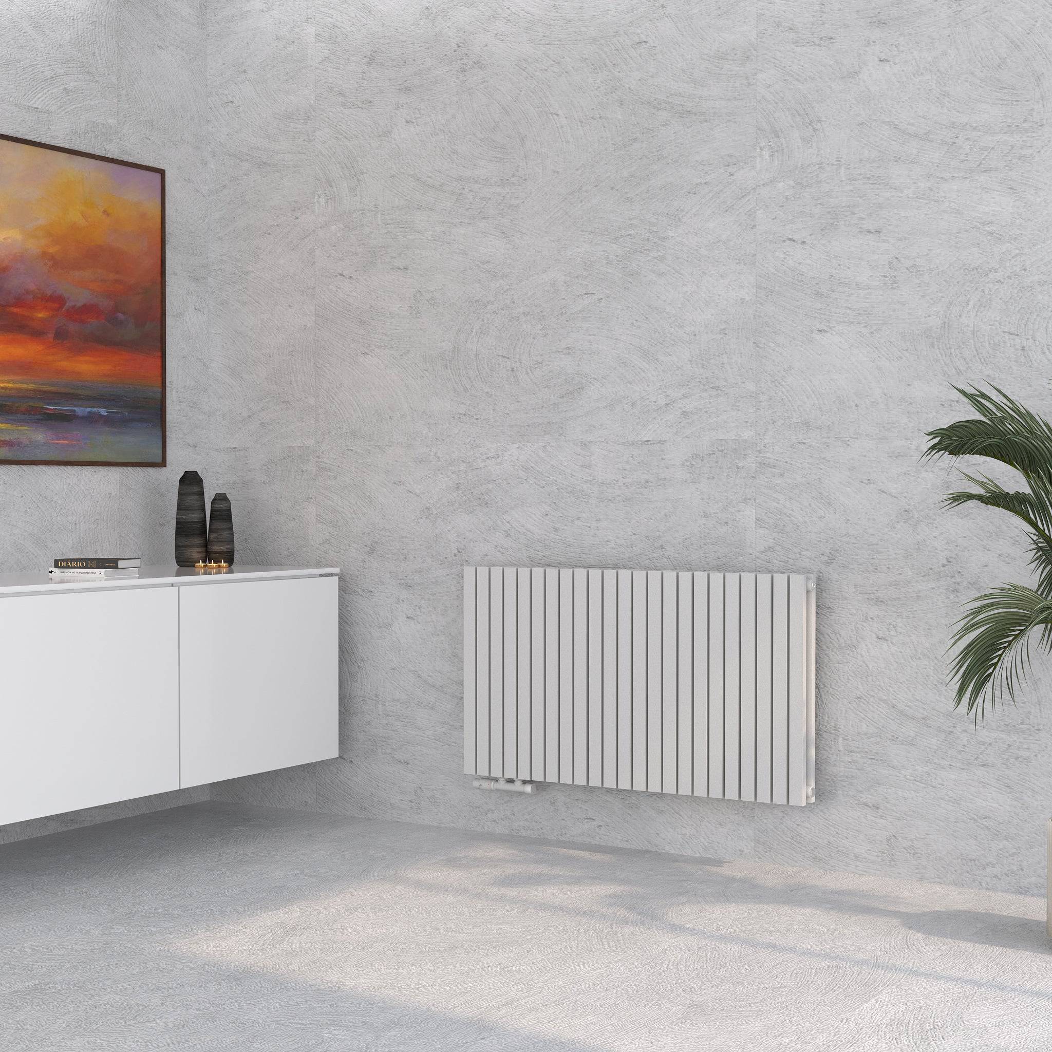 Demeter H Paneelheizkörper Weiß im Wohnzimmer neben Sideboard, Wandbild und Pflanze montiert